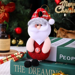 Detailed view of Santa Claus plush ornament with red plaid fabric and snowflake button detail