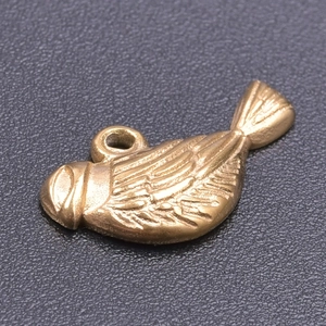 Macro shot of 18k gold plated bird pendant charm showing intricate feather texture detail