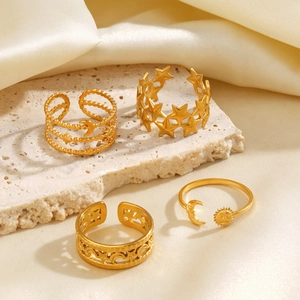Golden stainless steel celestial rings featuring sun, moon, and star patterns on stone