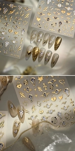 Detail of 3D metallic gold nail stickers featuring melting clocks and star motifs