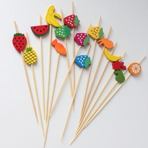 Bamboo fruit picks with colorful strawberry and pineapple shaped wooden decorations