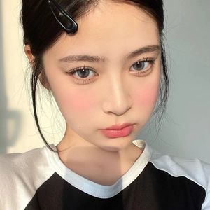 Classic black snap hair clip on Asian woman with light blue colored contacts
