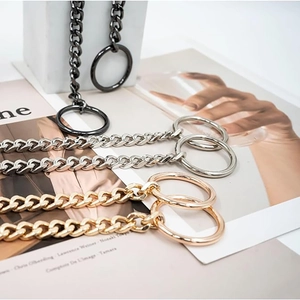 Detail of Y-shaped stainless steel Cuban chain necklaces in black, silver, and gold finishes