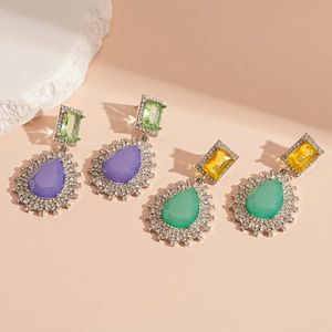 Vintage water drop earrings with colorful gemstones and rhinestones on a warm background