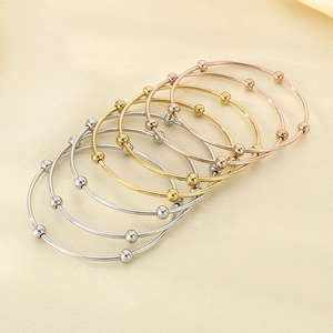Minimalist stackable round bangles in gold, silver and rose gold with metal bead accents