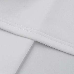 Close-up of the high-quality stitching and woven texture on a white off-shoulder dress