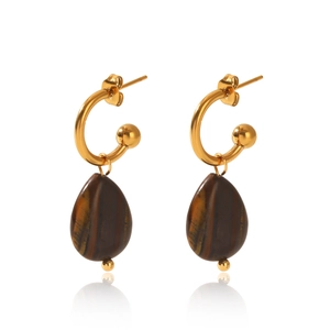 Detailed view of teardrop tiger eye stone earrings with polished gold-tone metal tassels