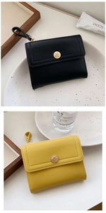 Close-up of black and yellow PU leather wallets with golden rose-shaped snap fasteners