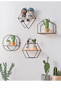 Detail of geometric metal wall shelves with light wood base for home storage
