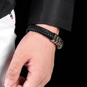Men's punk braided black leather bracelet with silver and gold metal clasps on wrist