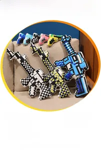 Detail of pixel style plush toy guns made of soft fabric with various color combinations
