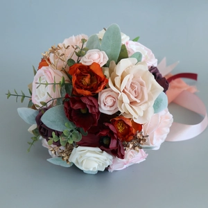 Elegant bridal bouquet with burgundy and pink silk roses and ribbons for outdoor weddings