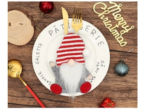 Close-up of Gnome cutlery holder on a white plate with festive Christmas dinner decor