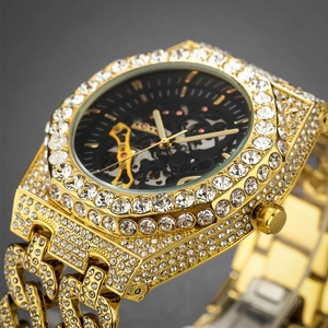 Close-up of golden iced-out mechanical watch featuring a skeleton dial and crystal settings