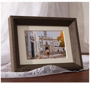 Close-up of solid walnut wood picture frame with rich grain and white matting