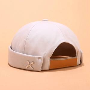 Detailed close-up of light gray docker cap featuring twill texture and metal X buckle
