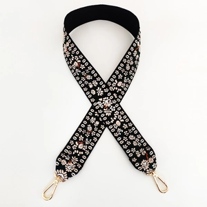 Detail of pink and white floral embroidery on thick black jacquard woven strap