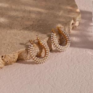 Close-up of 18K gold plated hoop earrings featuring micro pearl pavé setting on stone