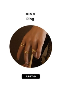 Detail of layered gold interwoven rings featuring minimalist streamlined wrap design