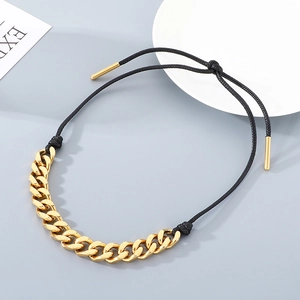 Detail of adjustable golden cuban link chain with black woven rope and metal tips