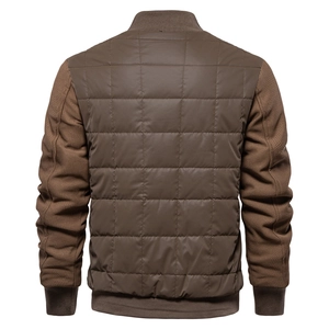 Detail view of the quilted back and mixed fabric sleeves on this brown outdoor jacket