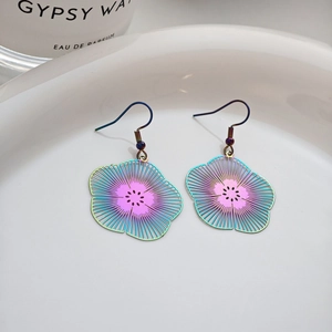 Bohemian retro colorful floral hollow drop earrings on a minimalist ceramic plate