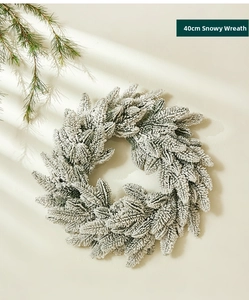 Close-up of 40cm frosted Christmas wreath with realistic pine needles and artificial snow