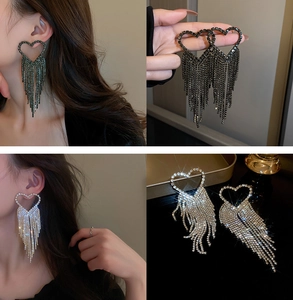 Detailed shot of U-shaped silver needle tassel earrings with heart hollow diamonds