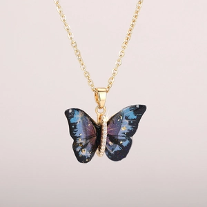Detail showing blue celestial butterfly pendant with gold sparkles and zircon crystals