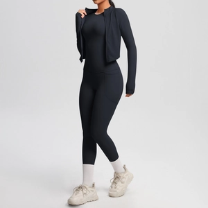 Close-up of black yoga set with side pockets, high-waisted leggings and slim jacket