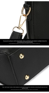 Detail of lychee pattern black leather bag with gold hardware and protective base studs