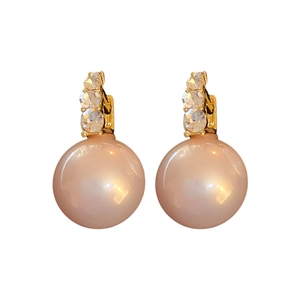 Vintage gold drop earrings with sparkling crystals and elegant pink pearls on white background