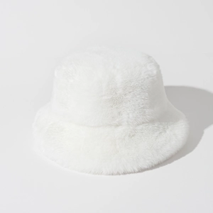 Close-up of the plush white faux fur texture and soft fabric of the winter bucket hat