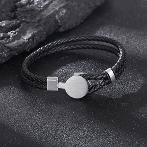 Detail of double-layer braided black leather bracelet with silver metal magnetic clasp