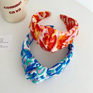 Floral knot headbands set with red and blue abstract patterns on wide fabric