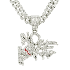 Detail of silver iced-out NO LOVE pendant with red cracked heart on Cuban chain