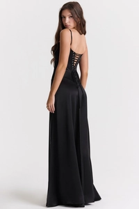 Detail of the cross-strap back design on a black satin evening dress with silky texture