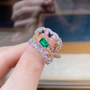 Close-up of S925 silver rings with emerald green gemstone and pavé zircon stones