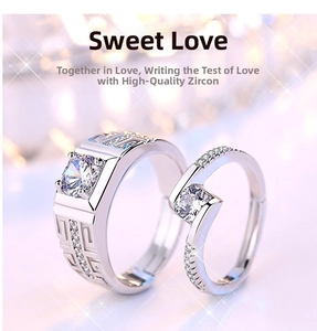 Macro view of couple rings with pattern engraving and high-quality zircon in silver finish