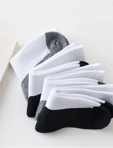 Detail of white cotton athletic socks with reinforced black toe and heel contrast design