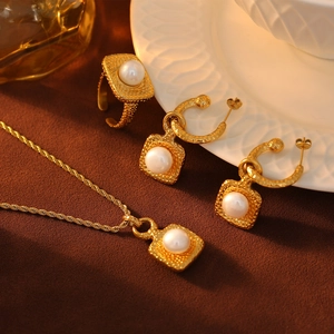 Elegant gold hammer-textured jewelry set with pearls including necklace, ring and earrings