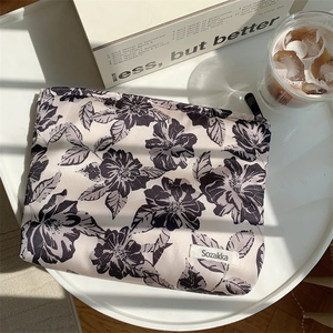Floral cotton makeup bag with black rose pattern on grey fabric with shadow details