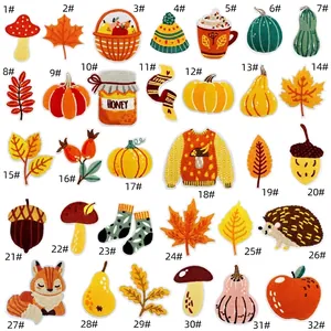 Detail of 32-piece autumn themed embroidered patches set featuring pumpkins and maples