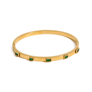 Gold-plated stainless steel hinge bangle featuring five rectangular green cubic zirconia stones