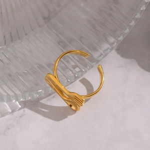 Macro shot of unique gold fork and spoon open ring made of durable titanium steel