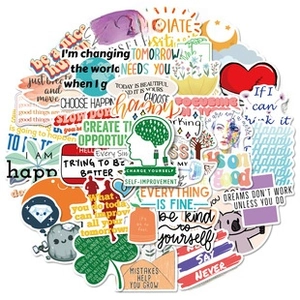 Flat lay close-up of vinyl stickers with English motivational quotes and slogans