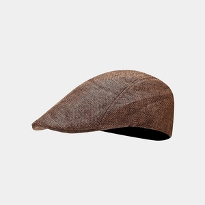 Close-up of a brown woven texture on a retro flat cap with detailed fabric grain