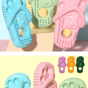 Detail of slipper-shaped dog teething toy with massage bumps in multiple colors