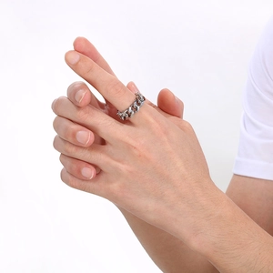 Close-up of silver Cuban link chain ring in titanium steel on a finger