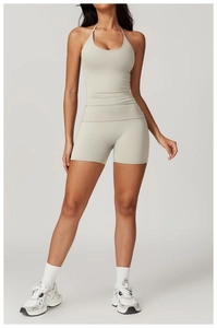 Detailed knit texture of sage green halter yoga top and high-waisted shorts set